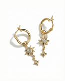 Gold hoop earrings with star-shaped charms on a white background