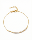 Gold bracelet with small diamonds on a white background