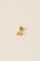 Gold earring on a beige background