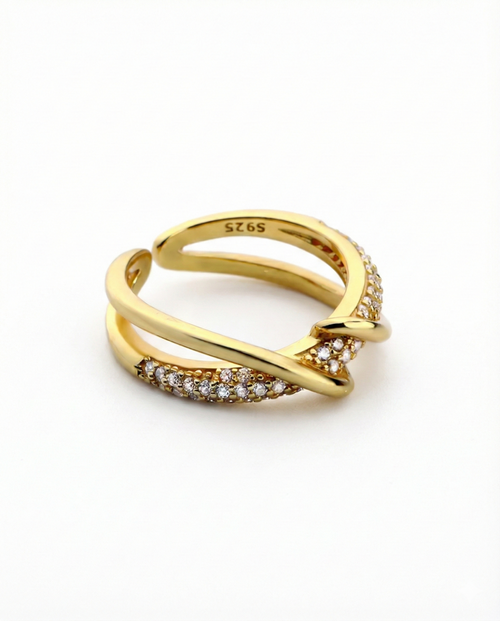 Gold ring with diamond accents on a white background