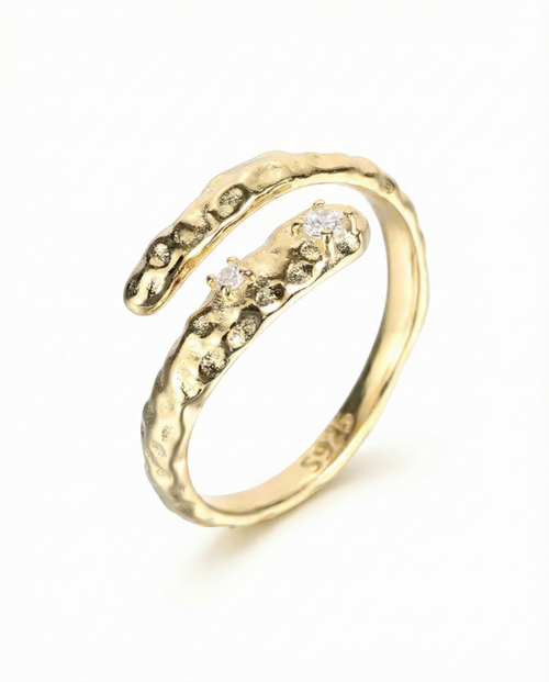 Gold ring with diamond accents on a white background